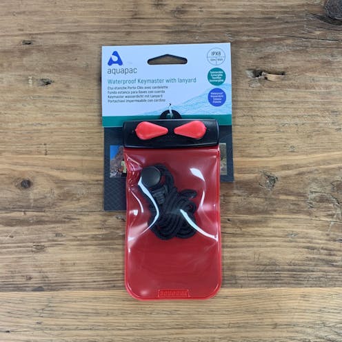 The Aquapac Keymaster in Red. Wooden Background.
